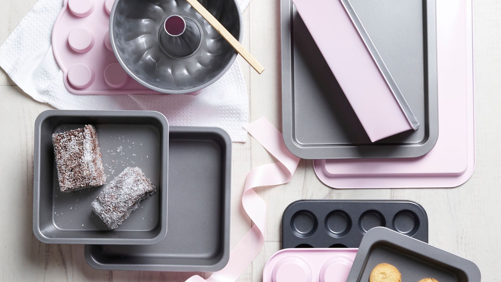 Assorted cookie, cake and loaf pans in grey and baby pink