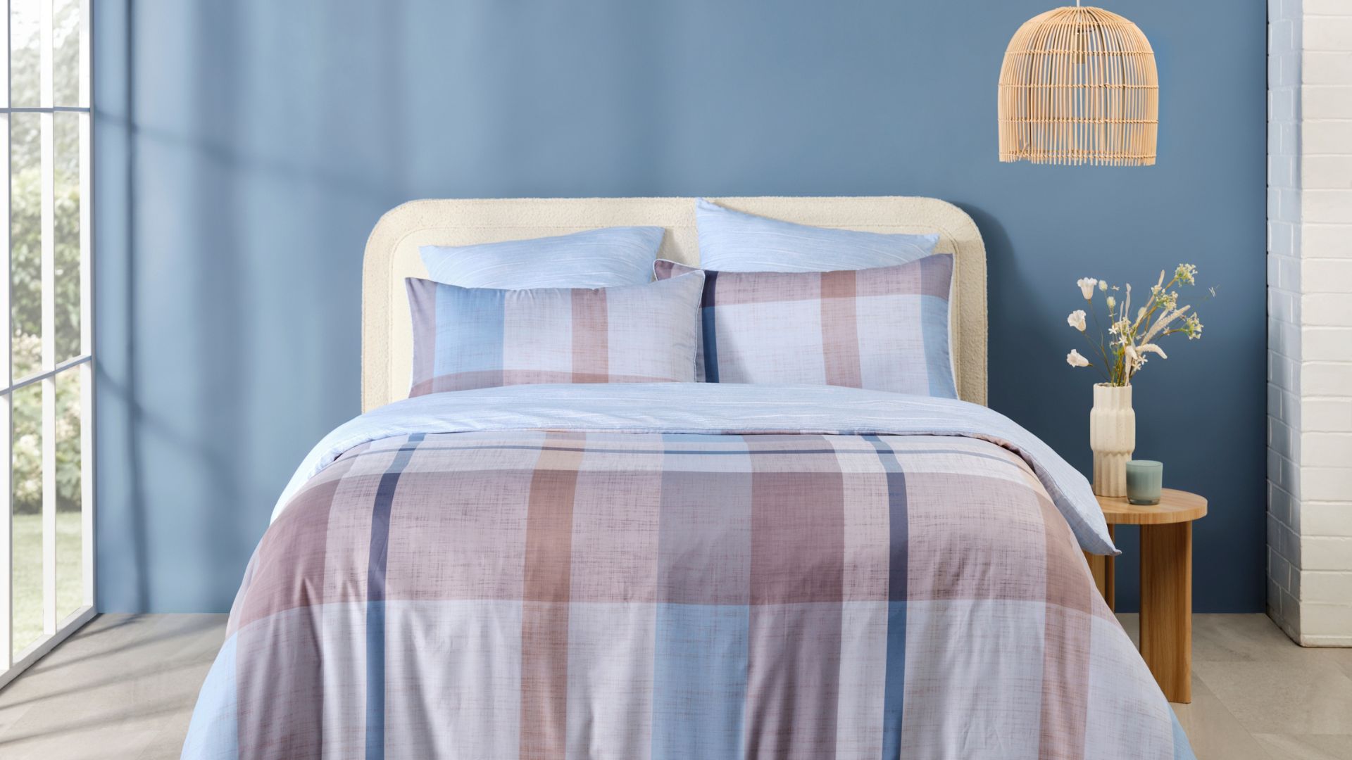 Light blue and brown check quilt cover matching with the bedroom steel blue coloured feature wall