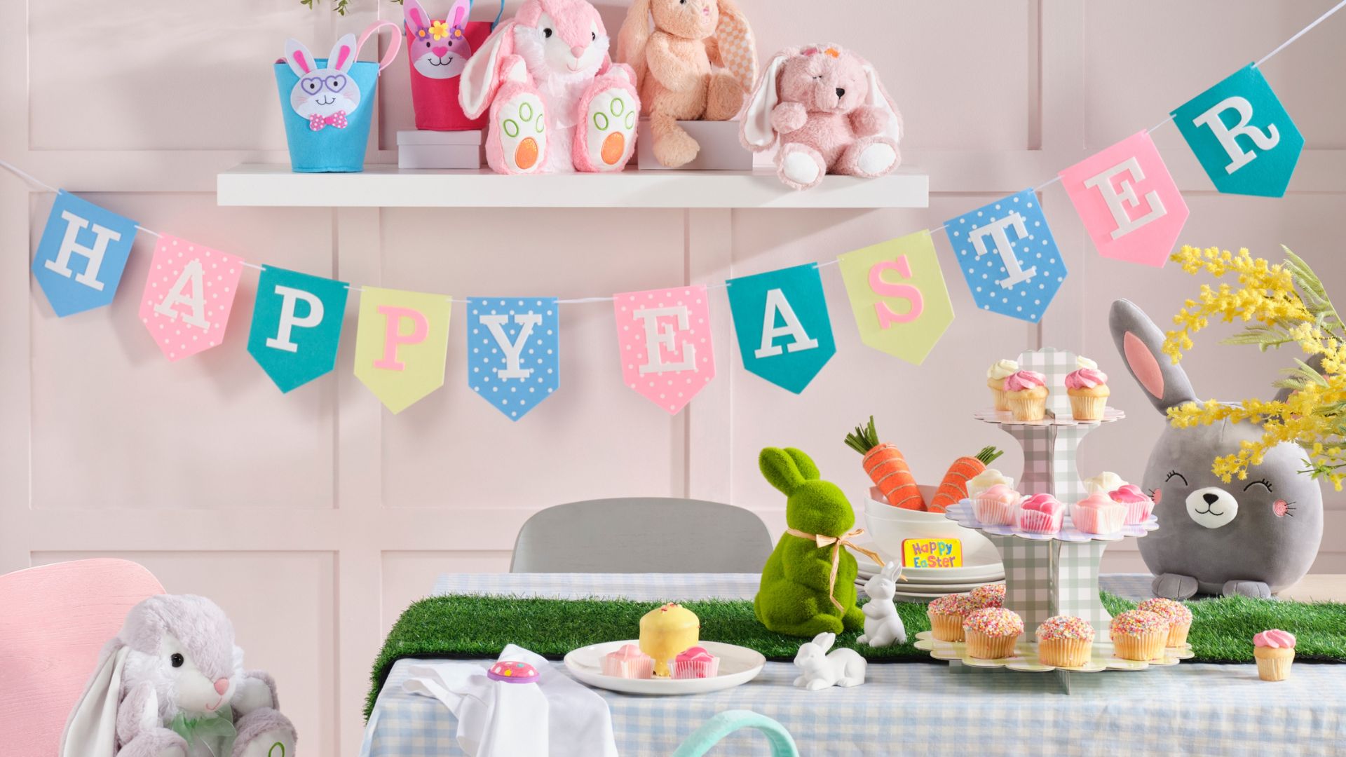 Happy Easter bunting, rabbit themed table decor, turf grass table runner and cupcakes