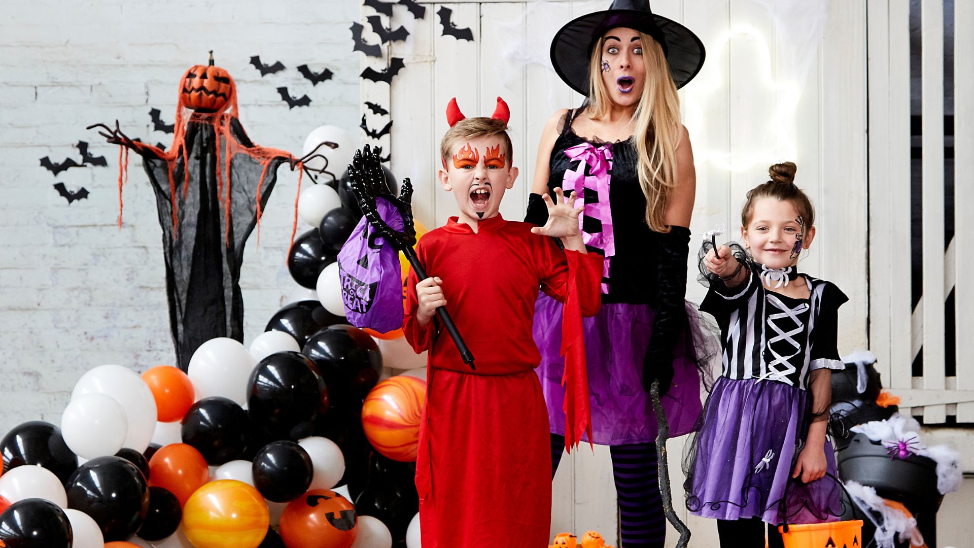 Dress up in spooky Halloween costumes for a trick-or-treating walk