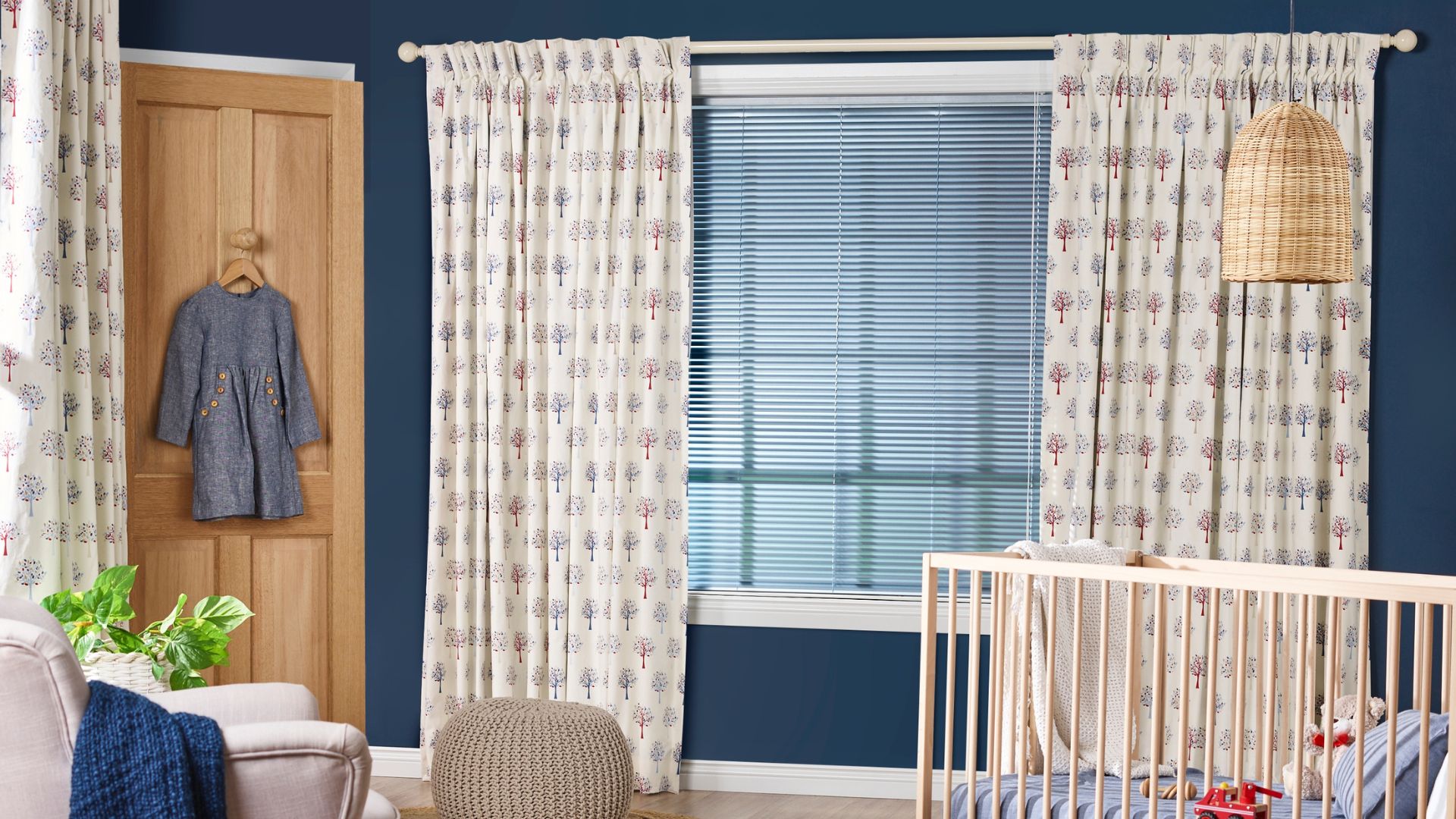 Venetian blinds layered with printed fabric curtains