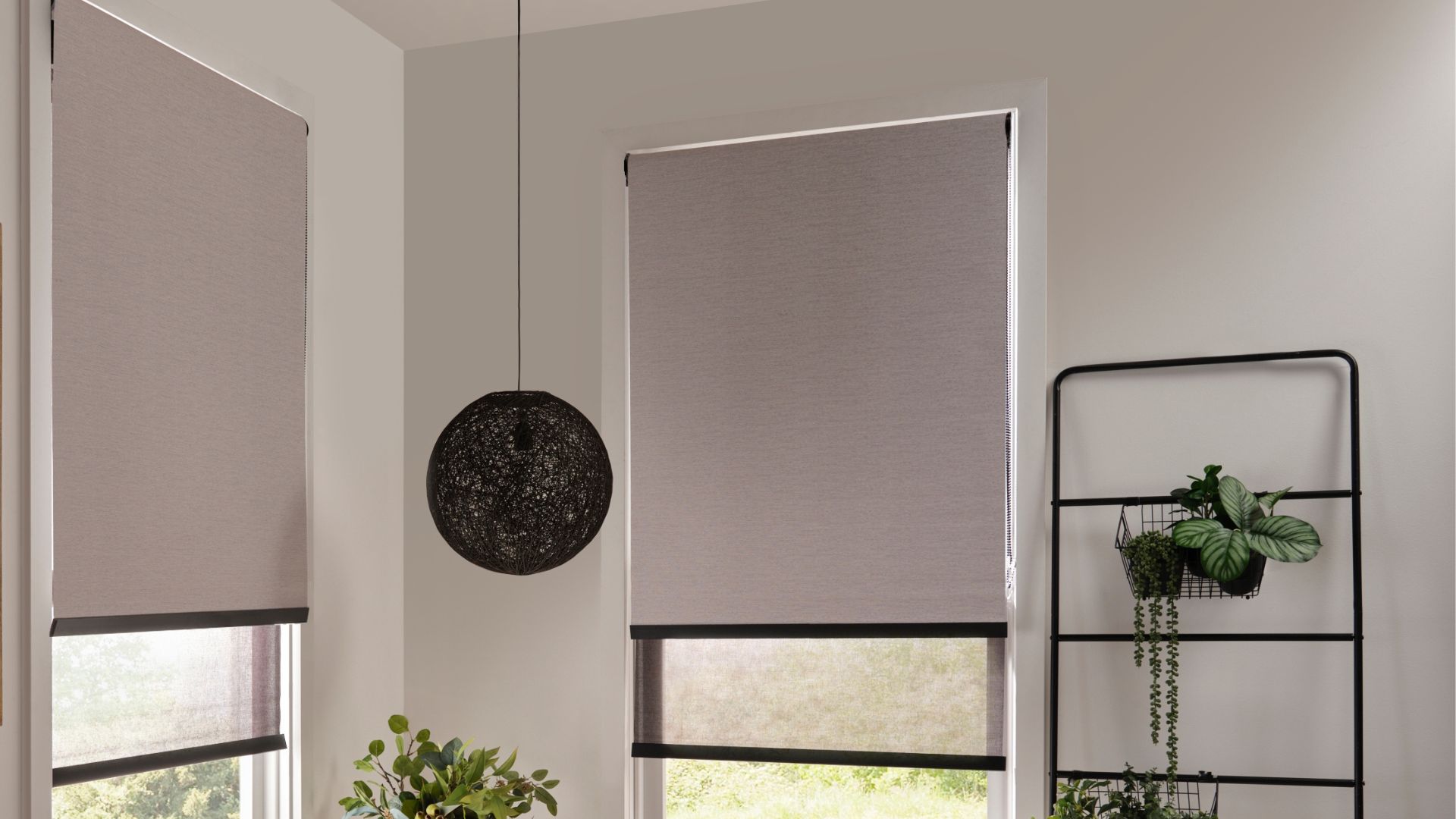 Layered grey blockout roller blinds