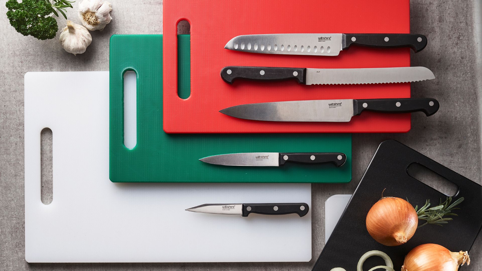 Set of black, white, green and red plastic chopping boards