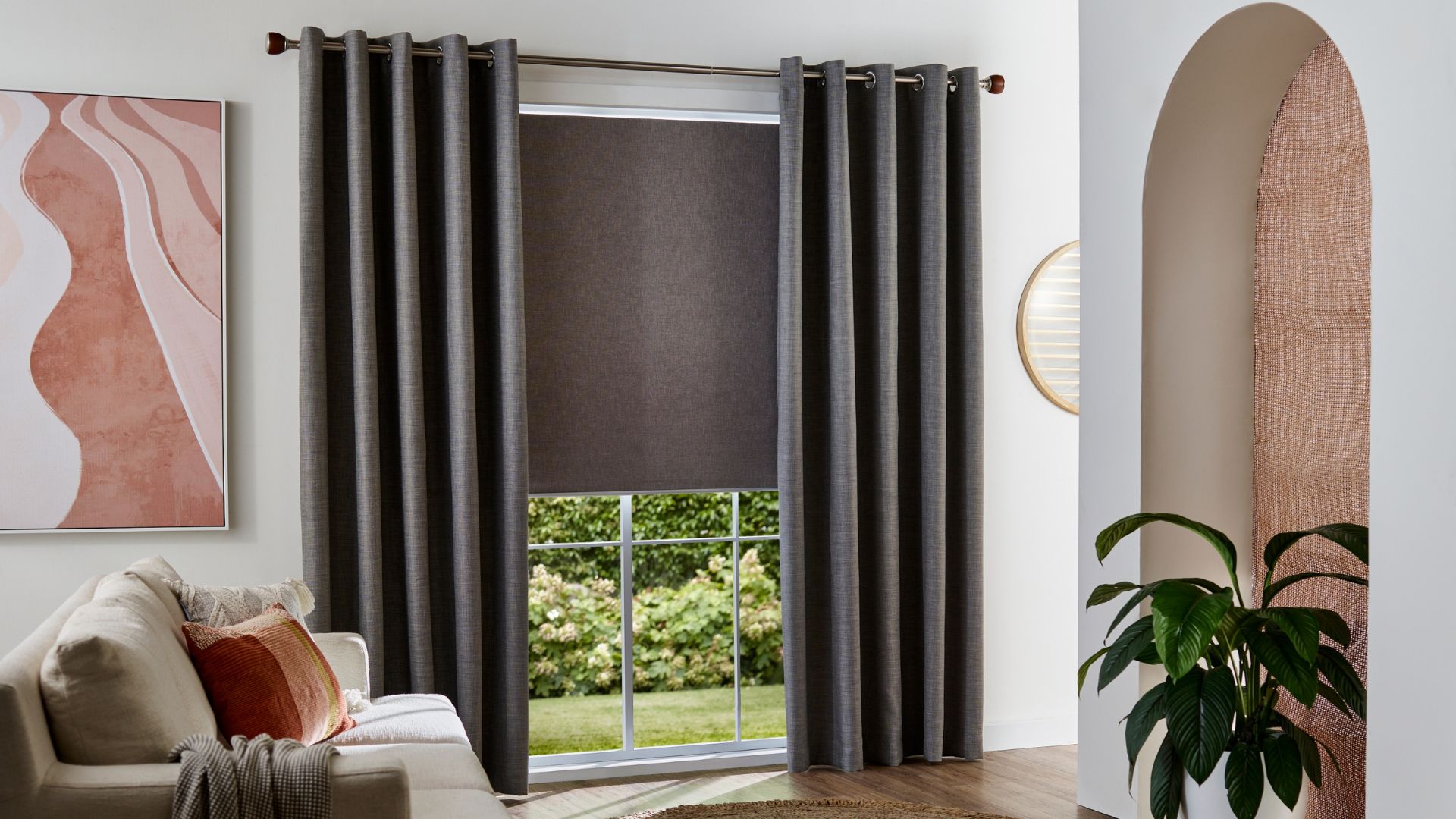 Matching warm grey roller blinds and curtains