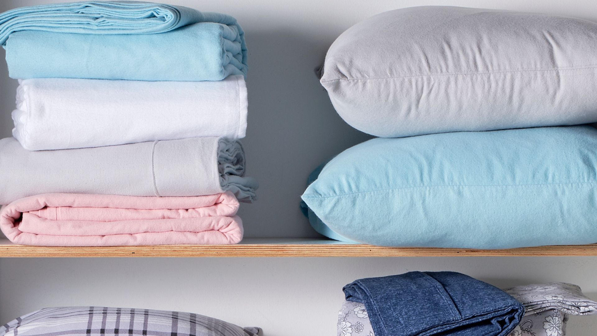 Folded bed sheets and pillows in storage