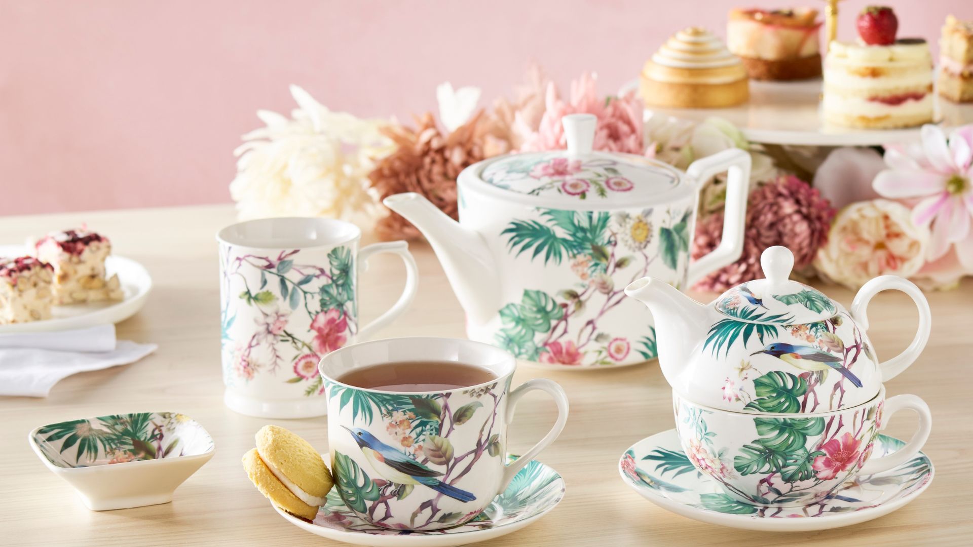 Teapot and teacup saucer set with a floral fauna design