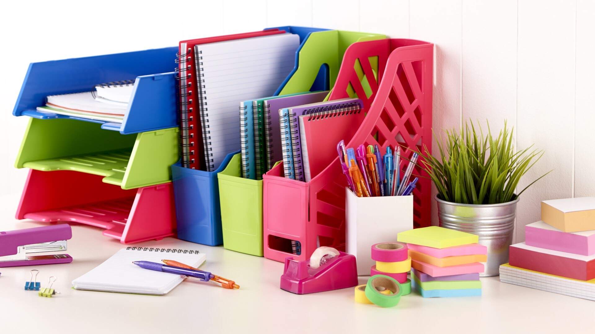 Vibrant coloured office organisers and desk set up
